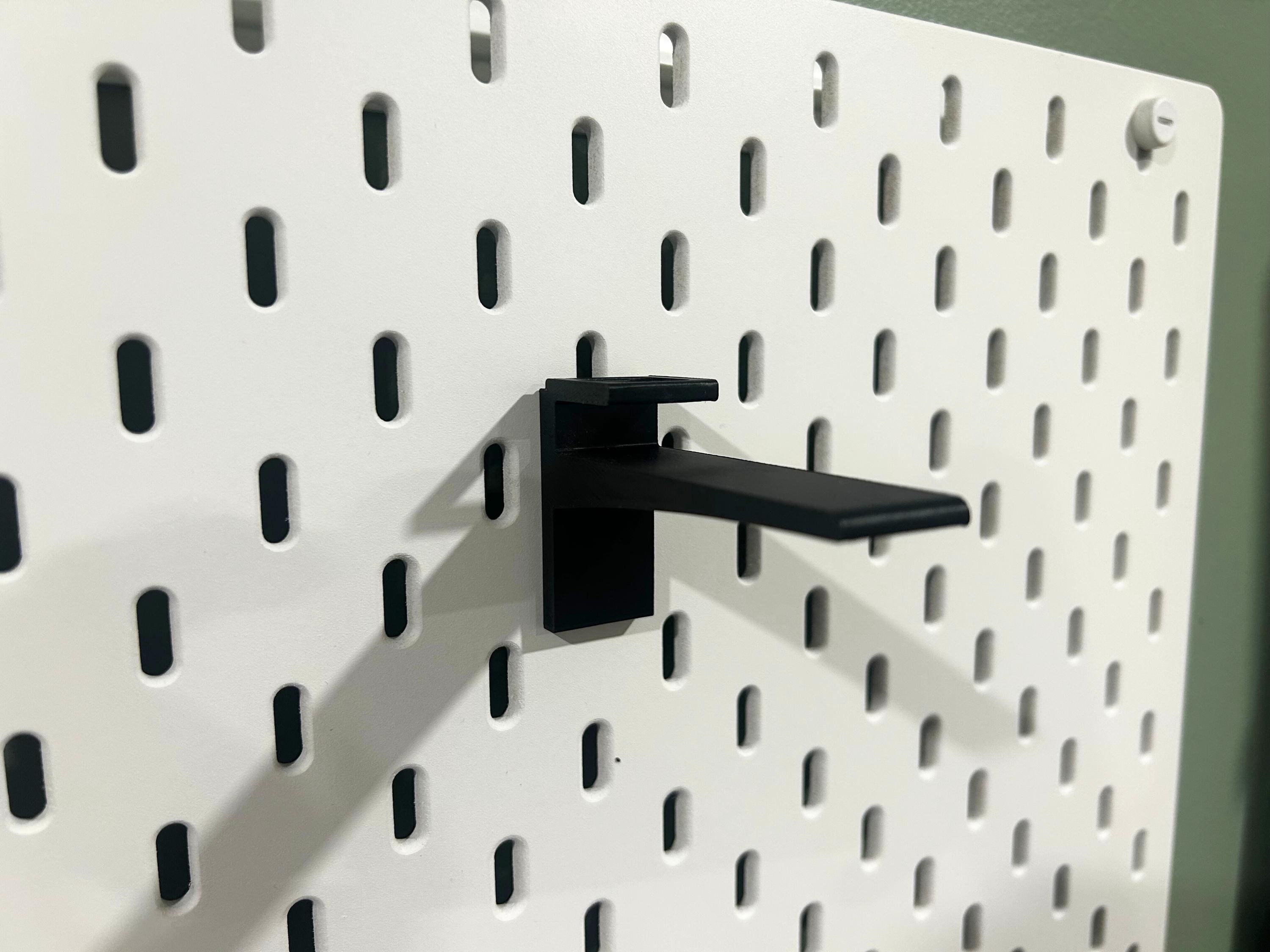 Black Ikea Skadis hat display mount.
